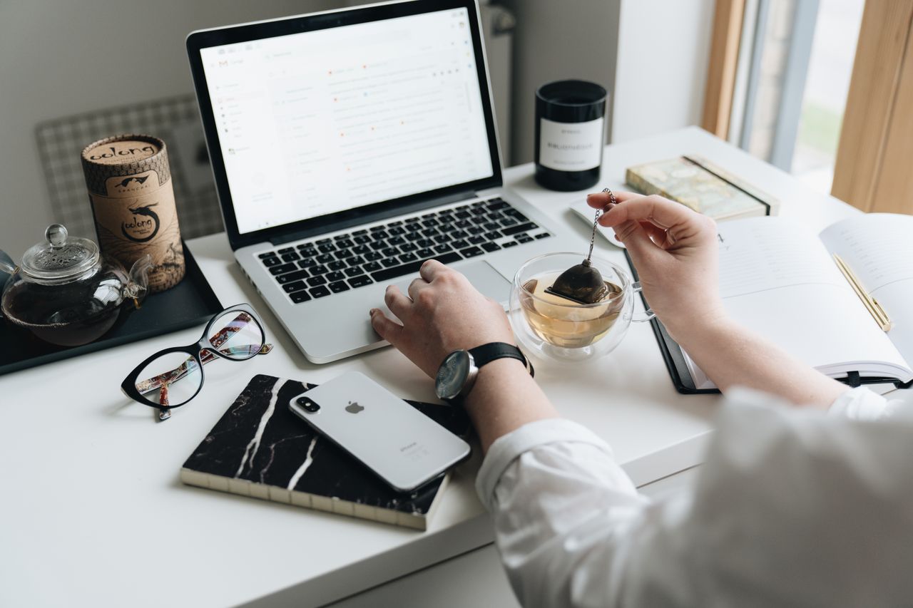 A marketer designing an email newsletter on a laptop
