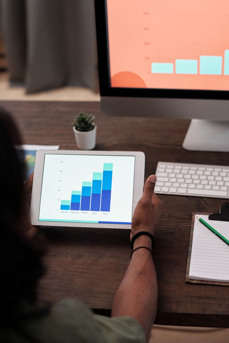 A small business owner reviewing email campaign analytics on a tablet